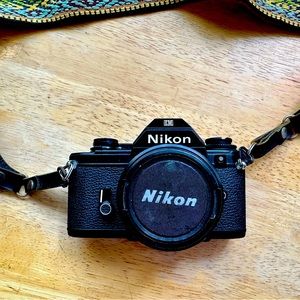 Vintage 1970s Nikon 35 mm film camera and strap